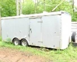 A trailer parked in the grass

AI-generated content may be incorrect.