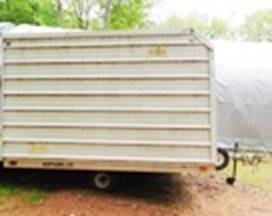 A trailer with a tarp

AI-generated content may be incorrect.